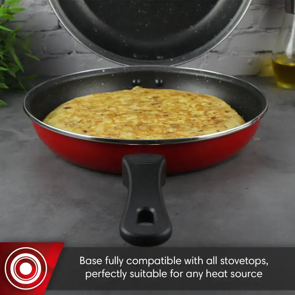 Bottom view of the open Magefesa double pan showing the Spanish omelette inside and ergonomic handle design.