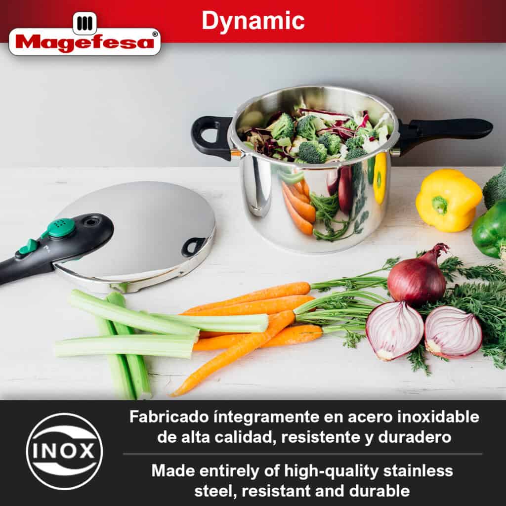 Magefesa Dynamic pressure cooker open on a kitchen table, with the pot containing food on one side and the lid placed separately.
